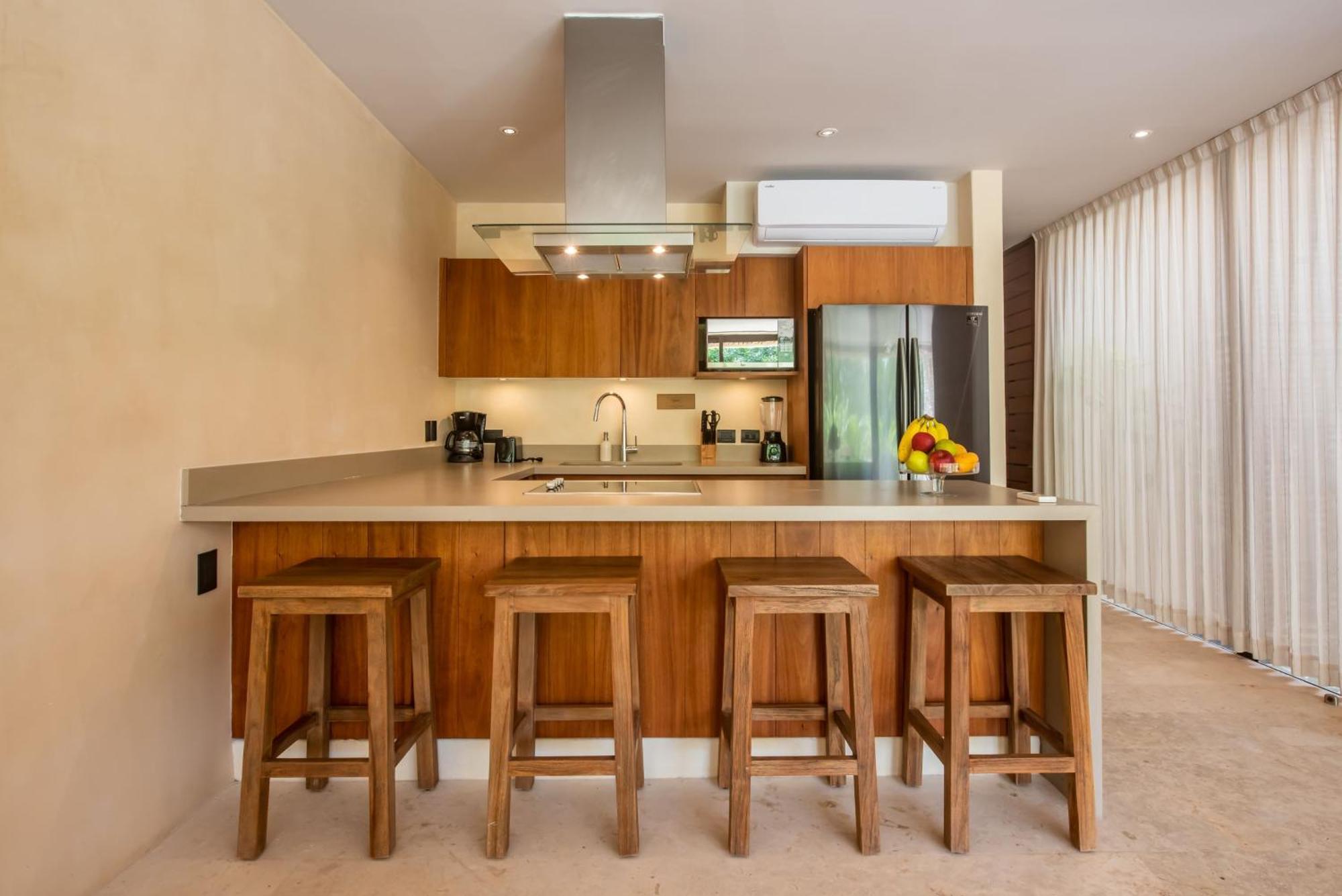 Copal Tulum Hotel Bagian luar foto A kitchen with a breakfast bar